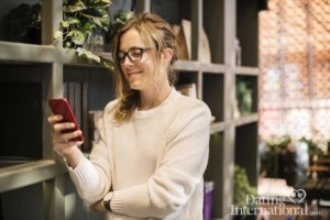 woman looking at dating profiles on her phone